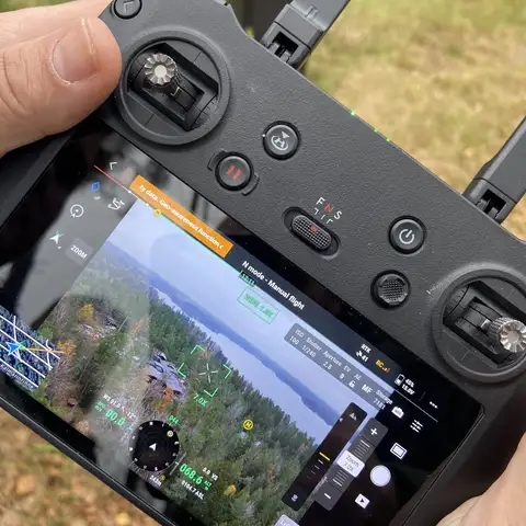 Drone controller screen showing an aerial view during a photo capture test.